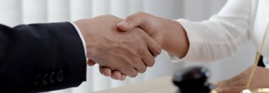 Avukatlar veya danışmanlar, davanın şirket, müzakere veya davaların çözümü konsepti tarafından sona erdirilmesini kutlamak için müvekkillerle el ele tutuşuyor..