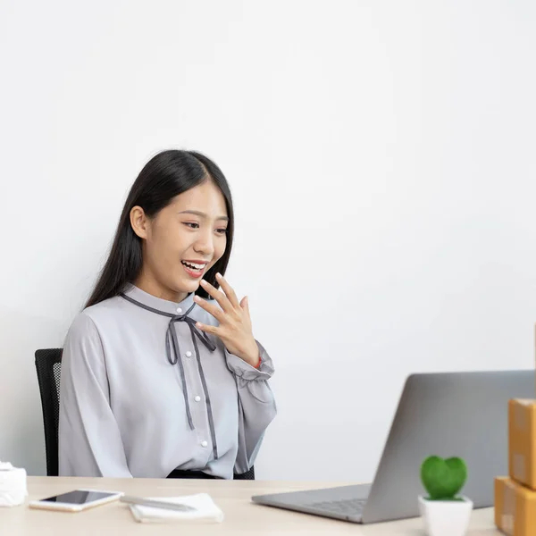 Young woman was happy after receiving an order from an internet customer, Entrepreneurs selling products online or doing freelance work at home concept.