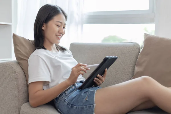 Asiatin Die Mit Einem Tablet Auf Dem Sofa Wohnzimmer Sitzt — Stockfoto