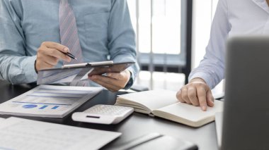 Brainstorm team, Marketers and financial accountants are discussing and analyzing charts to plan strategies to meet customer needs, Business data graph, Team meetings or business consulting.