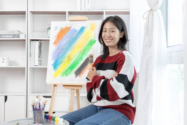 Female artist painting on canvas, Artist studio interior, Draw with watercolor, Drawing supplies , Painting and creativity, Use a brush to draw a pattern by stripes, Artwork, Using Paint Brush.