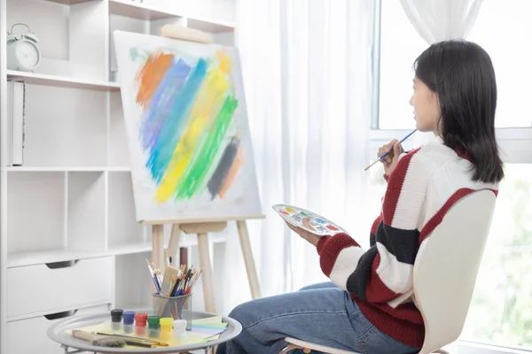 Female artist painting on canvas, Artist studio interior, Draw with watercolor, Drawing supplies , Painting and creativity, Use a brush to draw a pattern by stripes, Artwork, Using Paint Brush.