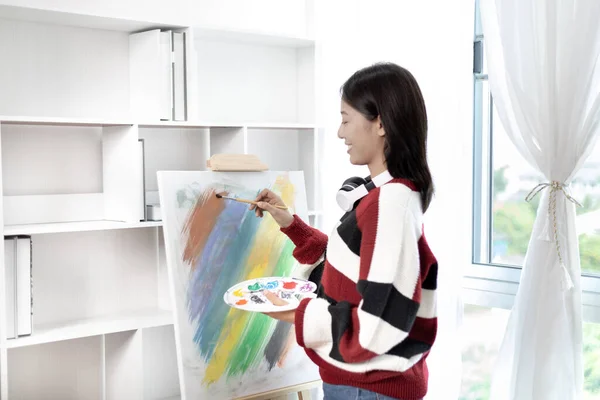 Female artist painting on canvas, Artist studio interior, Draw with watercolor, Drawing supplies , Painting and creativity, Use a brush to draw a pattern by stripes, Artwork, Using Paint Brush.