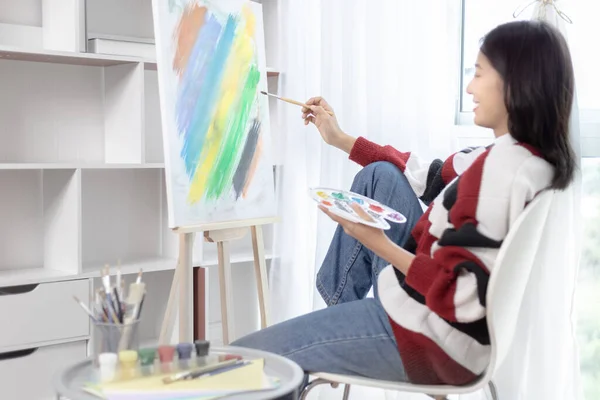 Female artist painting on canvas, Artist studio interior, Draw with watercolor, Drawing supplies , Painting and creativity, Use a brush to draw a pattern by stripes, Artwork, Using Paint Brush.