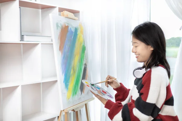 Female artist painting on canvas, Artist studio interior, Draw with watercolor, Drawing supplies , Painting and creativity, Use a brush to draw a pattern by stripes, Artwork, Using Paint Brush.