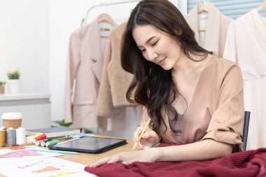 Professional female designers use a tape measure around the shirt in the studio, Fashion designer, Creativity and ideas, Mannequin, Shirt sketch, Color scheme, Garment accessories.