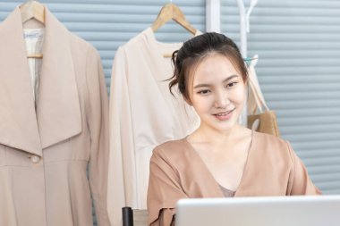 Professional female designer sketches of clothes through laptop in the design studio, Fashion designer, Creativity and ideas, Mannequin, Shirt sketch, Color scheme, Garment accessories ,Freelance.