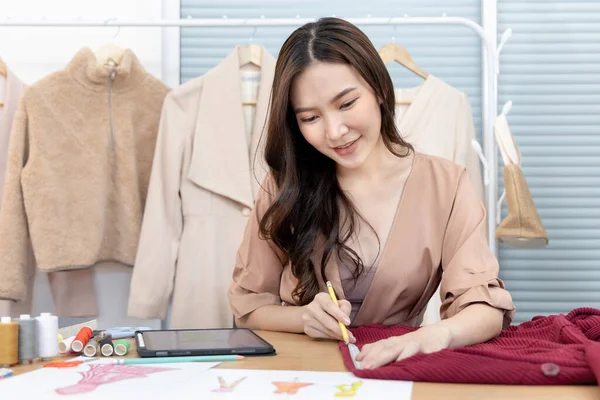 Professional female designers use a tape measure around the shirt in the studio, Fashion designer, Creativity and ideas, Mannequin, Shirt sketch, Color scheme, Garment accessories.