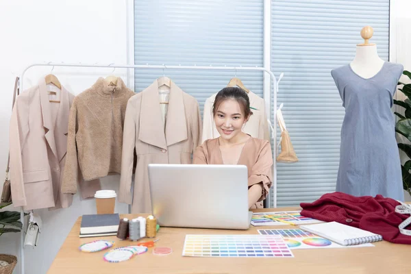 Professional female designer sketches of clothes through laptop in the design studio, Fashion designer, Creativity and ideas, Mannequin, Shirt sketch, Color scheme, Garment accessories ,Freelance.