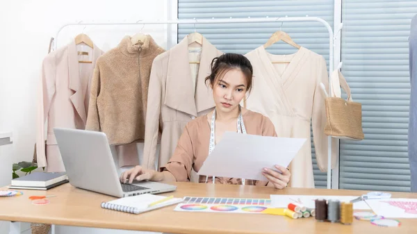 Professional female designer sketches of clothes through laptop in the design studio, Fashion designer, Creativity and ideas, Mannequin, Shirt sketch, Color scheme, Garment accessories ,Freelance.