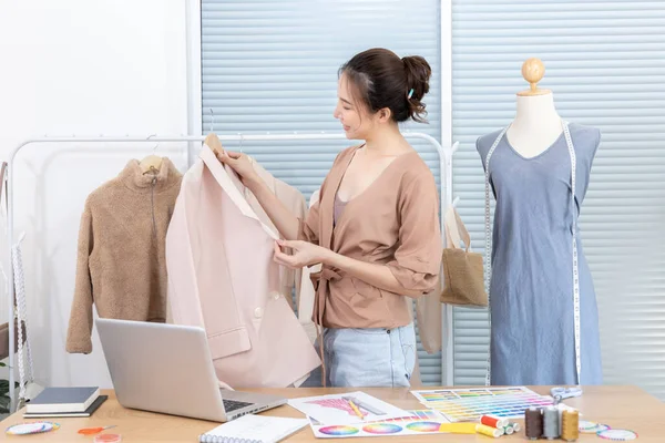 Professional female designers use a tape measure around the shirt mannequins in the studio, Fashion designer, Creativity and ideas, Mannequin, Shirt sketch, Color scheme, Garment accessories.