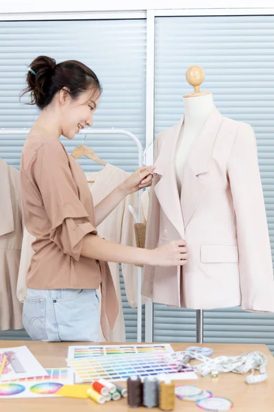 Professional female designers use a tape measure around the shirt mannequins in the studio, Fashion designer, Creativity and ideas, Mannequin, Shirt sketch, Color scheme, Garment accessories.