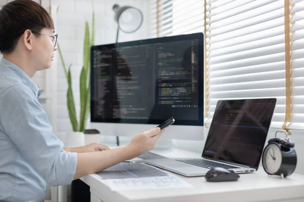 Professional development programmers are using mobile phones to test the functionality of their applications after programming, Write data or code for websites and applications,  HTML, javascript, Software.