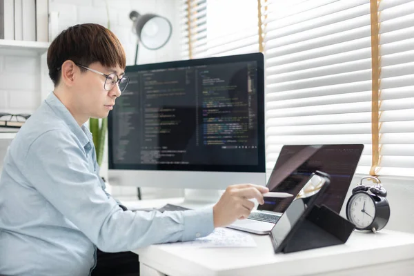 Professional development programmers are using tablet to test the functionality of their applications after programming, Write data or code for websites and applications,  HTML, javascript, Software.
