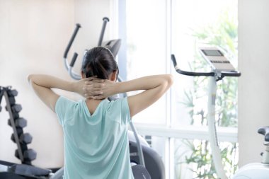 Beautiful and shapely Asian woman working out in the gym, Play exercise machine treadmill, Dumbbell, stretching, Hanging bar, Barbell, Cardio, Stretch, Woman warming up in the gym, Jump rope.