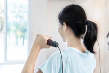 Beautiful and shapely Asian woman working out in the gym, Play exercise machine treadmill, Dumbbell, stretching, Hanging bar, Barbell, Cardio, Stretch, Woman warming up in the gym, Jump rope.