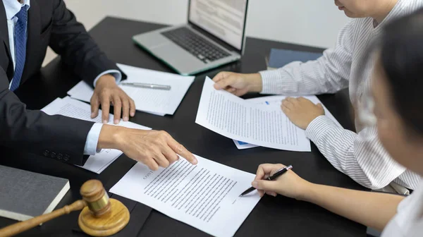 Lawyer or judge has recommend a client sign a legal agreement in the courtroom, Legal Agreement Documents and Business Litigation Forms, scales of justice, law hammer, Litigation and legal services.