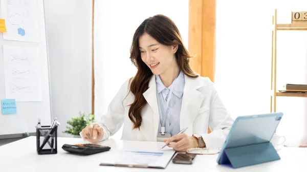 Asian business women are analyzing graphs, Financial statistics and calculating corporate returns in private offices, Market research reports and income statistics, Financial and Accounting concept.