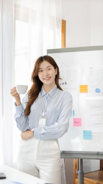 Office worker with a beautiful Asian woman in a private office, Daily routine of office workers, Welcome to work in the morning with a bright smile, Businesswoman in office concept.