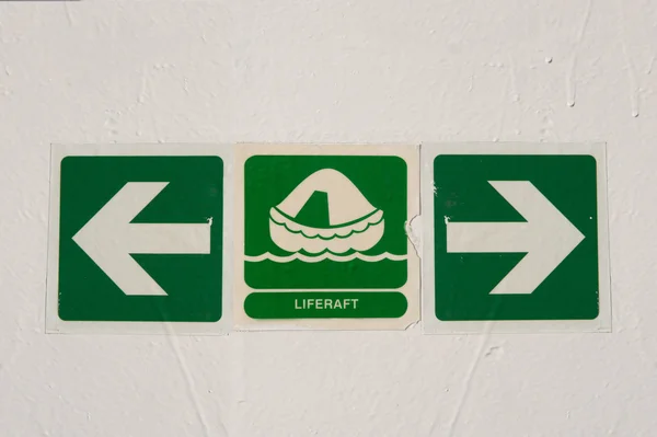 Liferaft an arrows signs on freshly painted ferry's wall — Stock Photo, Image