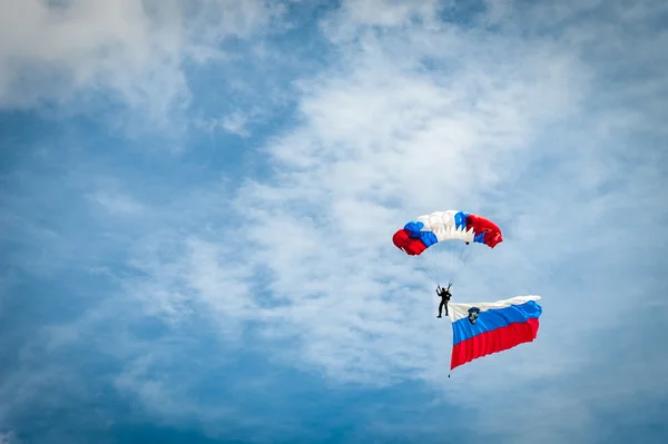 Skydiver with Slovenian flag and parachute in colors of Slovenia