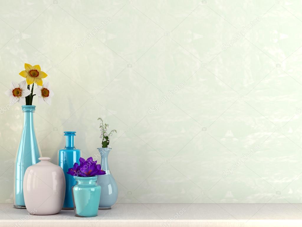 Blue vases with flowers against a green background