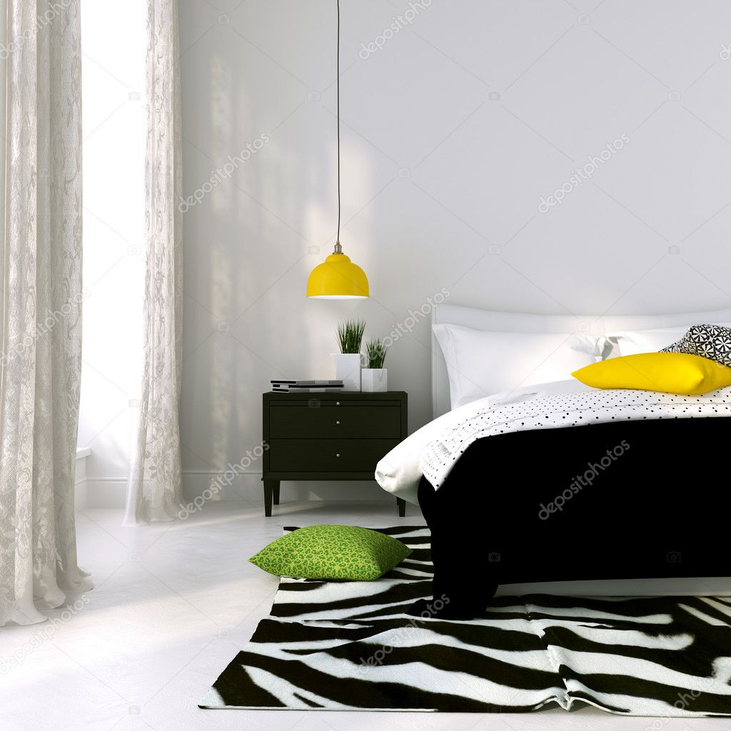 Black and white bed and a yellow lamp