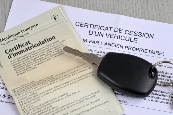 Official French administrative documents for the sale of a car with a key in close-up