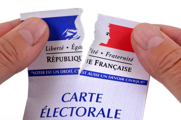 Concept of abstaining from elections with someone tearing up their french electoral card on white background