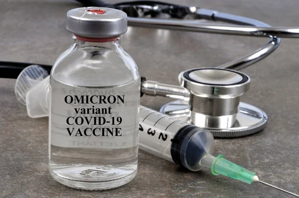 注射器や聴診器の横にあるバイアル中のオミクロンバリアントワクチン製品の概念 — ストック写真