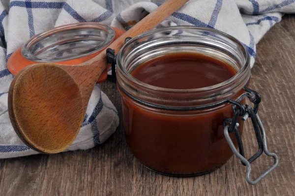 Jar Salted Butter Caramel Wooden Spoon Kitchen Towel Close — Stockfoto