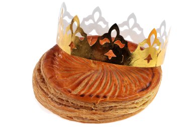 Galette des rois and its crown close-up on a white background 