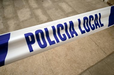 Plastic tape on which is written in Spanish local police