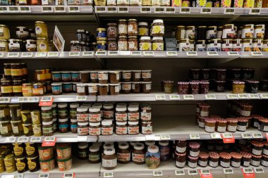 Supermarket shelf with jars of jam and spread 