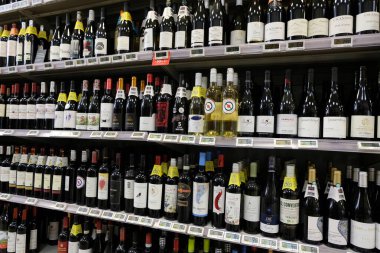 Bottles of wine on shelves in a supermarket 