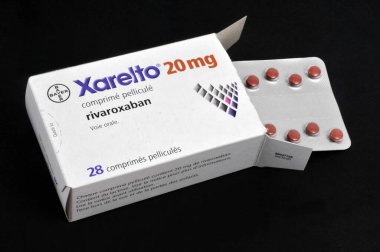 Box of Xarelto with a blister of drugs close-up on a black background 