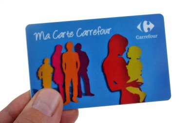 Carrefour store loyalty card held in hand close up on white background