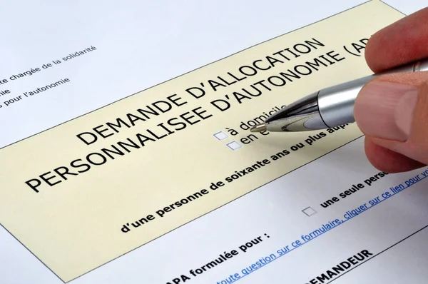 Filling Out French Personalized Autonomy Allowance Application Form Pen — Stok fotoğraf