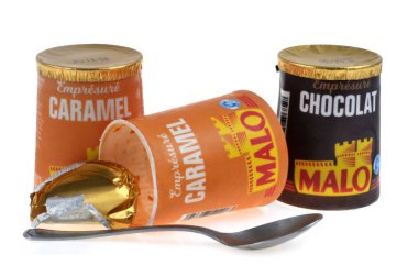 Jars of Malo brand caramel and chocolate yogurt close-up on a white background