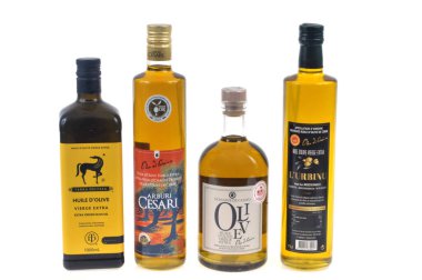 Bottles of olive oil of different brands close-up on a white background