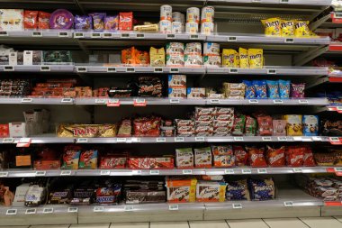 Shelves of different confectionery and chocolate brands of a french supermarket 