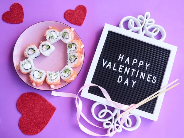 Sushi set in the shape of a heart on very peri background. Valentine day or March 8th food concept.The concept of a romantic dinner at a sushi bar for February 14th.