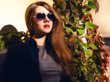 Girl with red hair and sunglasses