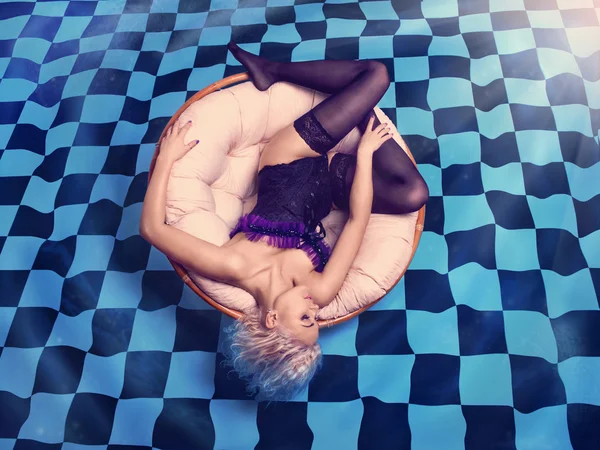 Hot blonde lying on the checkered pool — Stock Photo, Image