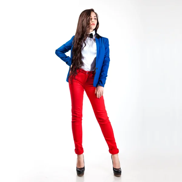 Sweet young woman in red pants and blue coat — Stock Photo, Image