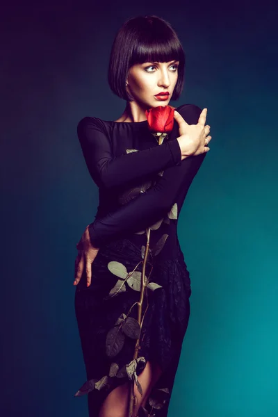 Brunette with red rose in studio — Stock Photo, Image