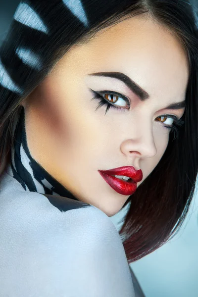 Portrait of fashion model in studio with stripes on hair in stud — Stock Photo, Image