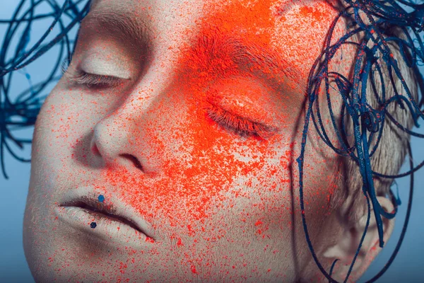 Macro portrait of woman with neon powder on face — Stock Photo, Image