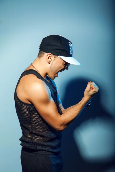 Profile portrait of strong man on blue background — Stock Photo, Image