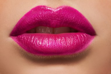 Macro photo of women's lips with pink lipstick